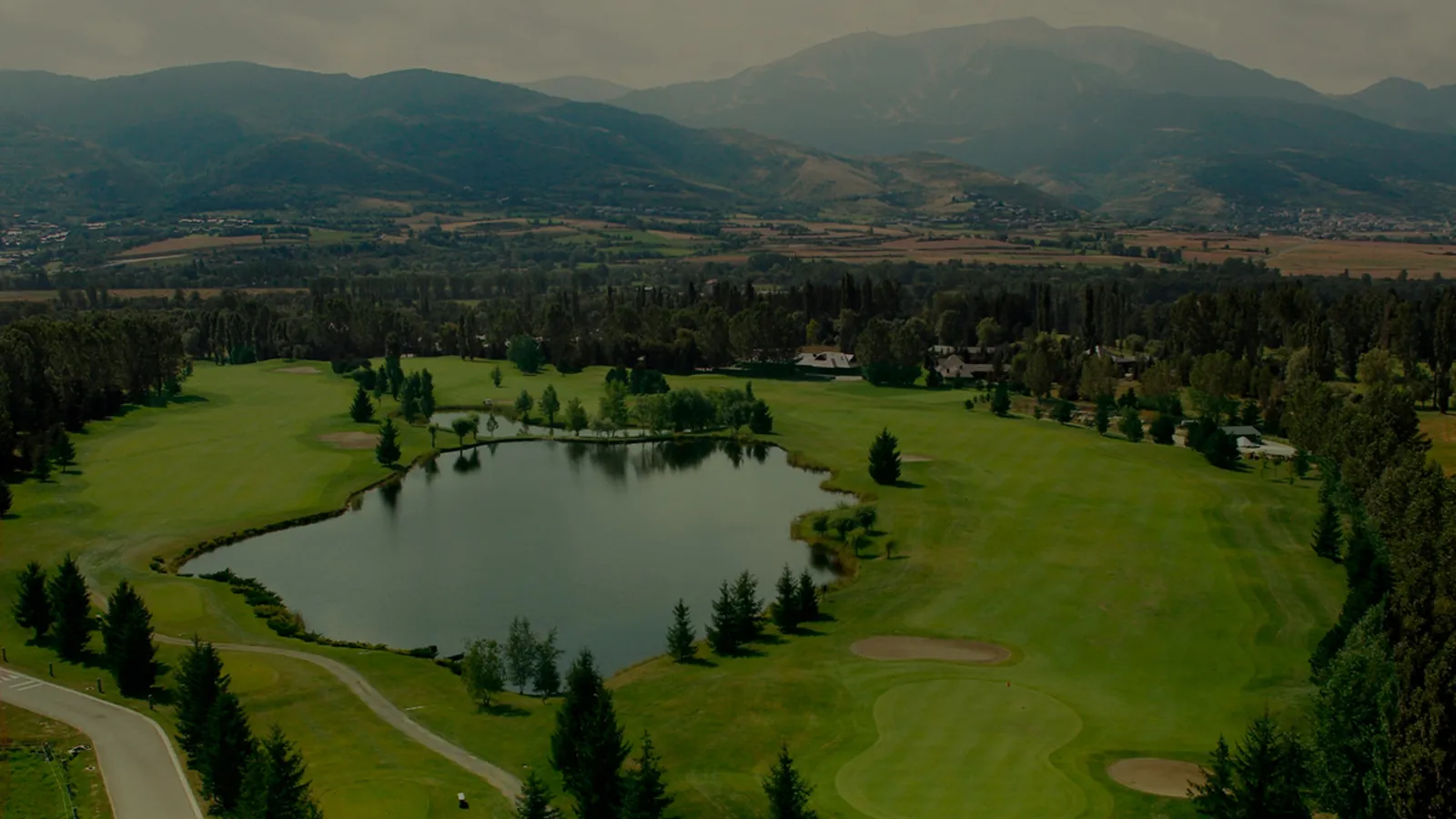Calle del Real Club de Golf de Cerdaña entre árboles centenarios, en el valle de la Cerdanya, Puigcerdà